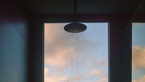 A shower with a view of a landscape through a large window. - CABN Kangaroo Island Ocean View Private Off Grid Luxury Accommodation (Willoughby)