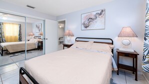 A bedroom with a bed, two bedside tables with lamps, a mirror, and a wall-mounted artwork. - Let's Spend Some Time Together (Wellington)