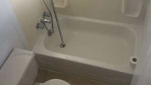 A bathroom with a toilet, a shower, and a bathtub. - Retro Cowboy Country Style Great Ranchhand Worker (Bethune)