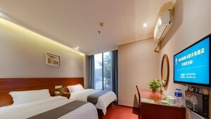 A hotel room with two beds, a desk with a computer, a TV, and a window with curtains. - Greentree Inn Nanjing Maqun Srt Ningzhi Rd Shell H (Nanjing)