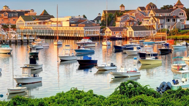 A marina with various boats docked, surrounded by residential buildings. - Hosting and Helping Other making Memories managed by Itrip Property Management (Barnstable)