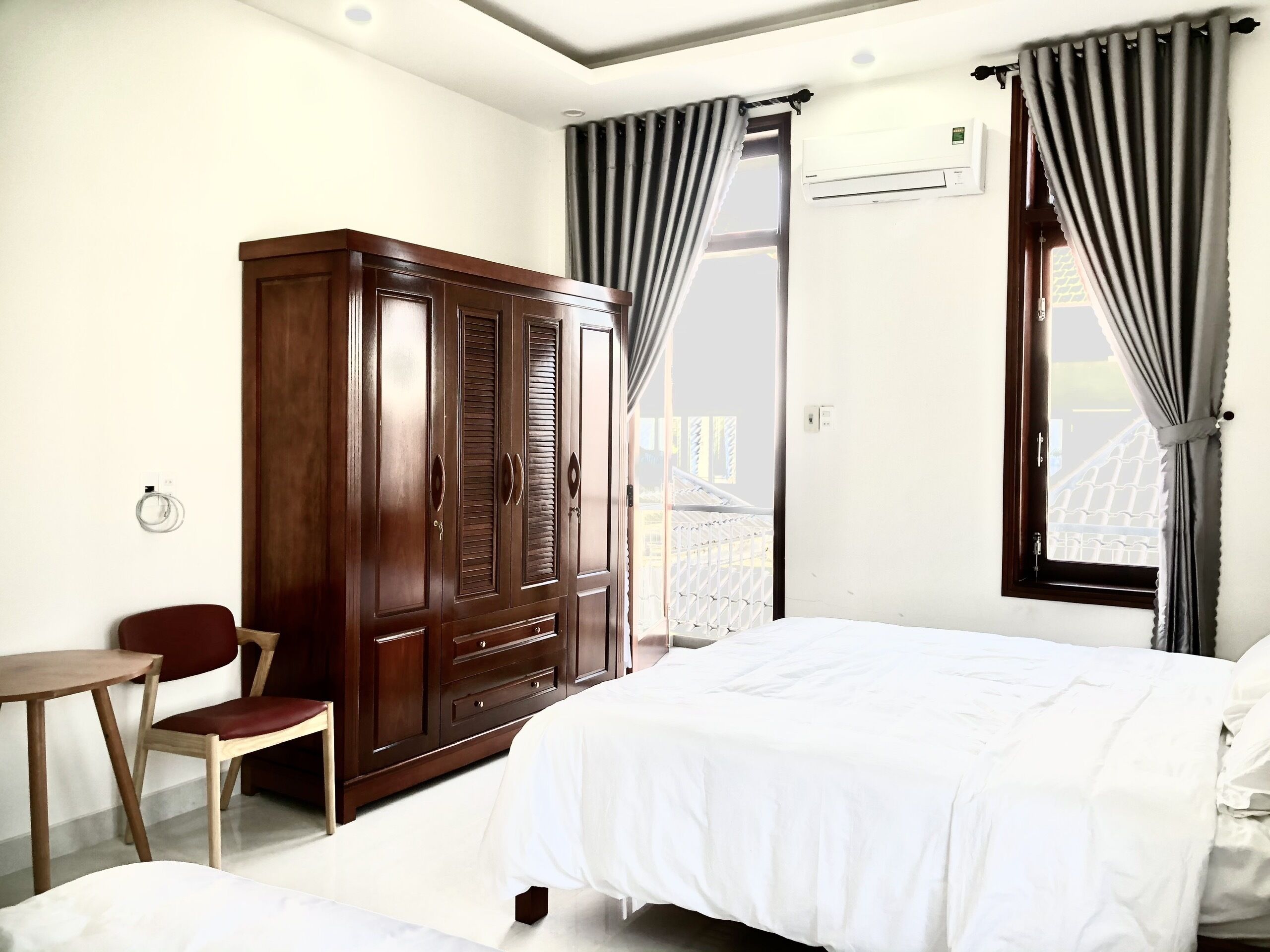 Premium bedding, desk, laptop workspace, blackout drapes