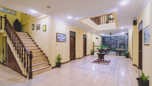 A spacious lobby with a staircase, a dining area, and a balcony. - PIA Hotel Medan (Medan)