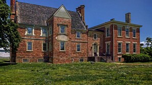 A large brick building with a central tower and a symmetrical facade.