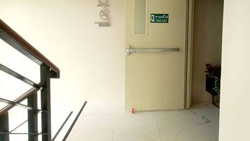 A stairway leading to a fire exit door with a sign indicating the exit.