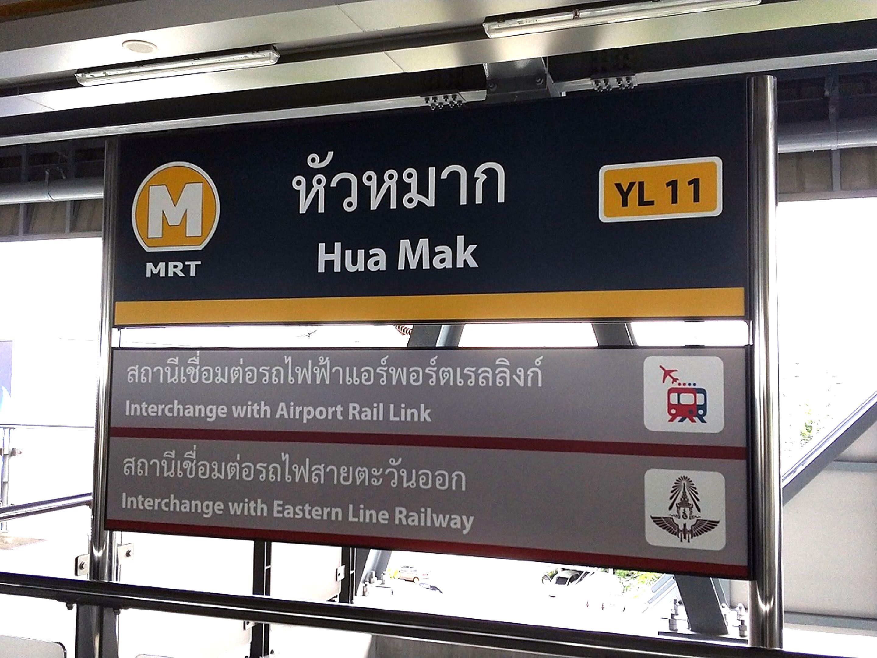 Un panneau indiquant la station MRT Hua Mak, avec des correspondances vers la ligne de liaison ferroviaire de l’aéroport et la ligne ferroviaire Est.