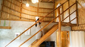A spiral staircase with wooden railings and a person descending.