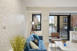 Relax in this stylish living room with a sofa, lamp, and city view.