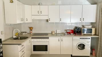 Frigorífico, microondas, cafetera o tetera y mesa de comedor