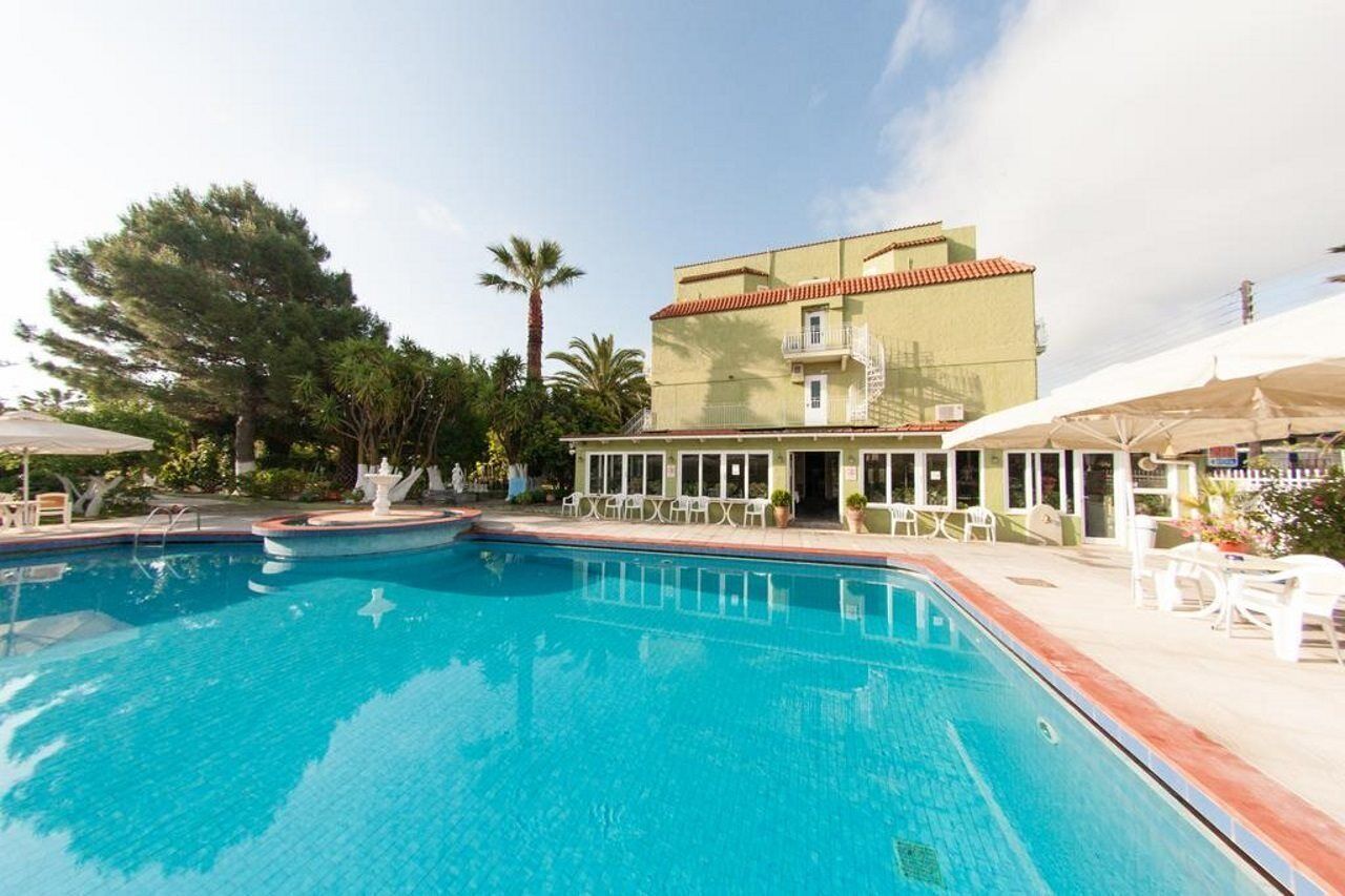 A swimming pool with a building in the background.