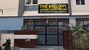 A multi-story building with a sign for "The Balcony Luxury Living Spaces" and a security camera above the entrance. - The Balcony Hotel (Hyderabad)
