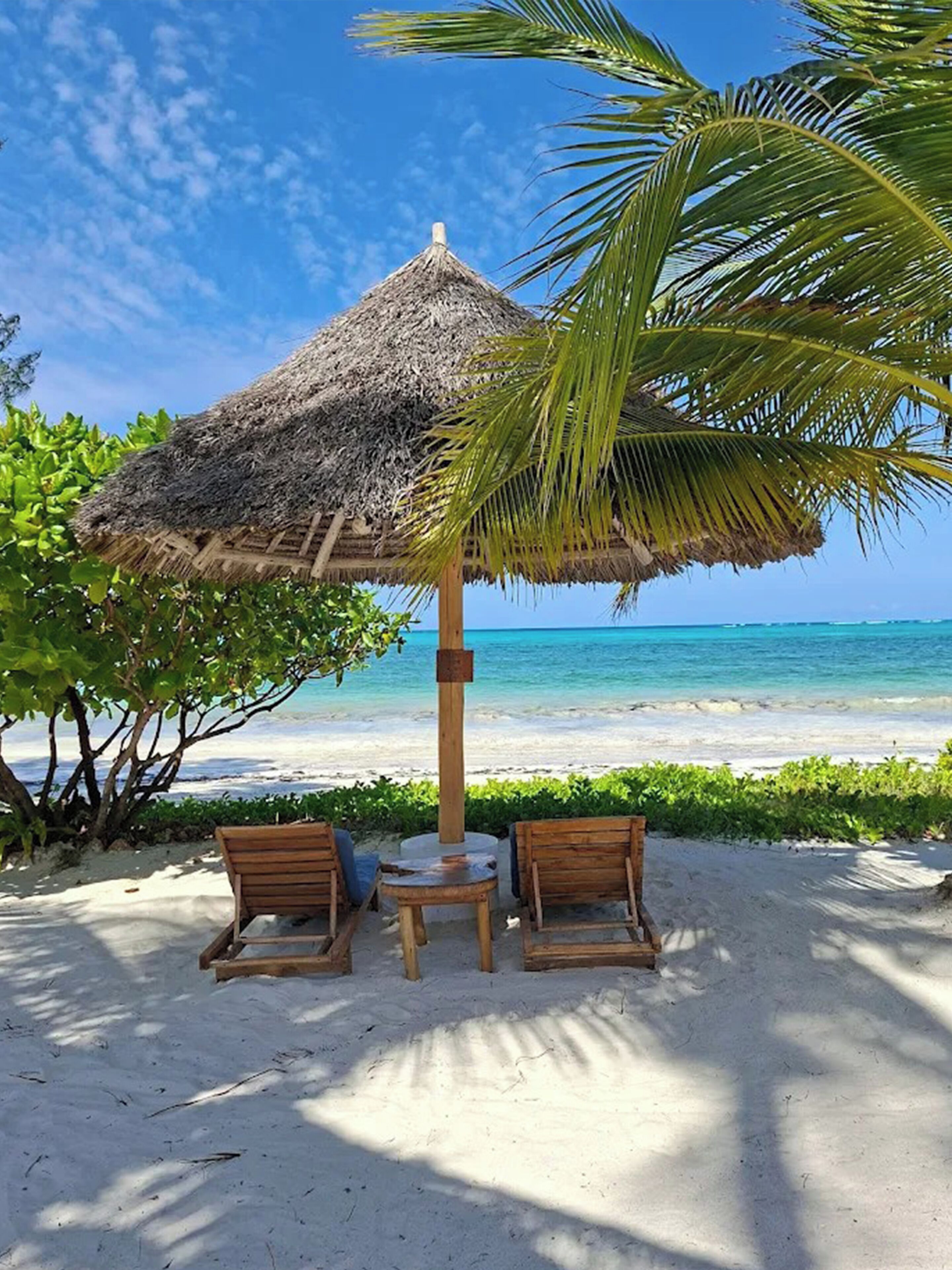 On the beach, white sand, sun loungers, beach umbrellas
