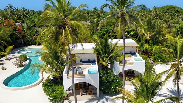 A resort with a pool, multiple rooms, and palm trees. - Kijani Beach Villas (Bwejuu)