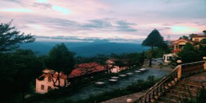 A view of a riverside area with buildings and trees. - Merostay 030  Nagarkot HillSide Village Resort (Baluwapati Deupur)