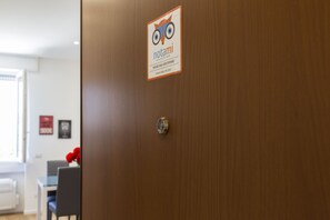 A wooden door with a sign that reads "notami" and "House San Cristoforo." - notaMI - House San Cristoforo M4 (Milan)