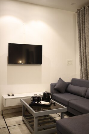 Luxury Studio Suite, 1 King Bed, City View | Living area | 40-inch Smart TV with digital channels, TV, Netflix - Gallivanto inn - Rohini (New Delhi)