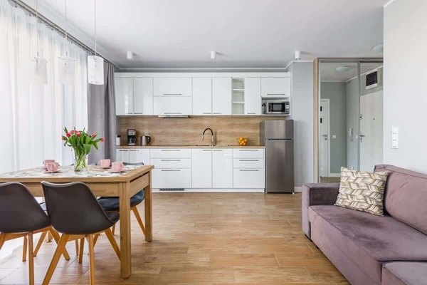 Living room with a dining table with chairs for four people.