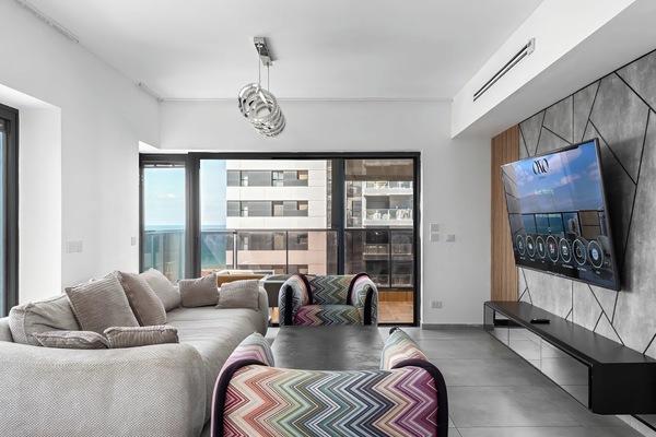 Spacious lounge with plush seating invites evenings together after beach walks and nearby dining adventures.