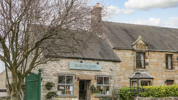 A stone building with a sign reading "The Hartington Cheese Shop." - Dove Meadows House (Buxton)