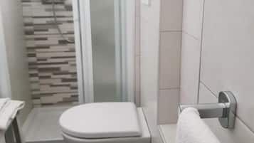 Een douche, een haardroger, een bidet, handdoeken