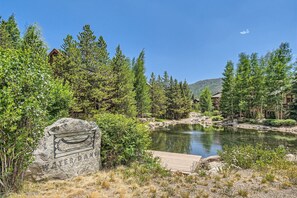 Enjoy serene lakeside views from the wooden dock, surrounded by lush greenery and mature trees.