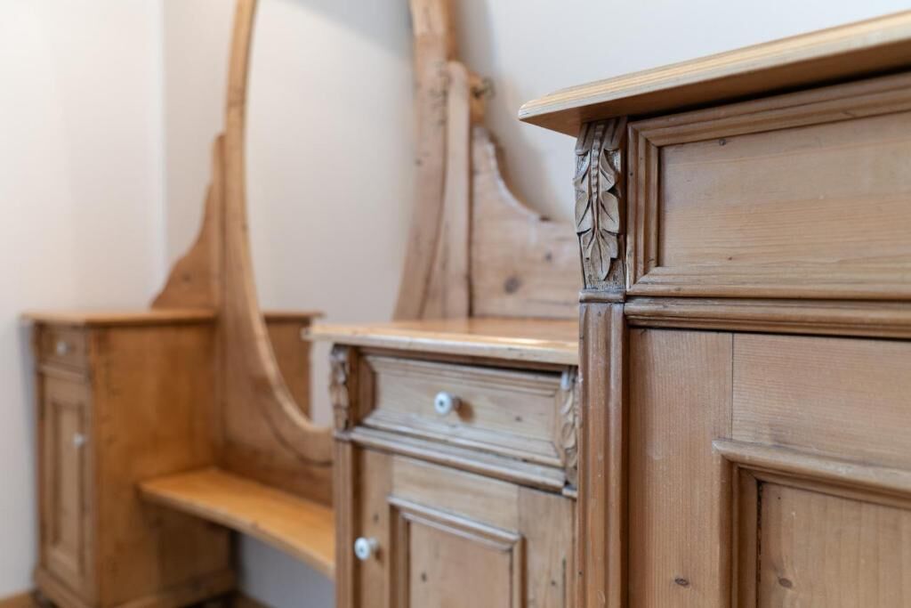 A wooden dresser with drawers and a shelf.