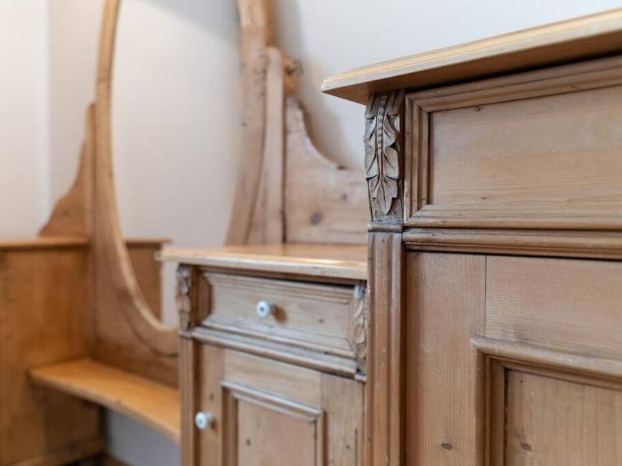 A wooden dresser with drawers and a shelf.