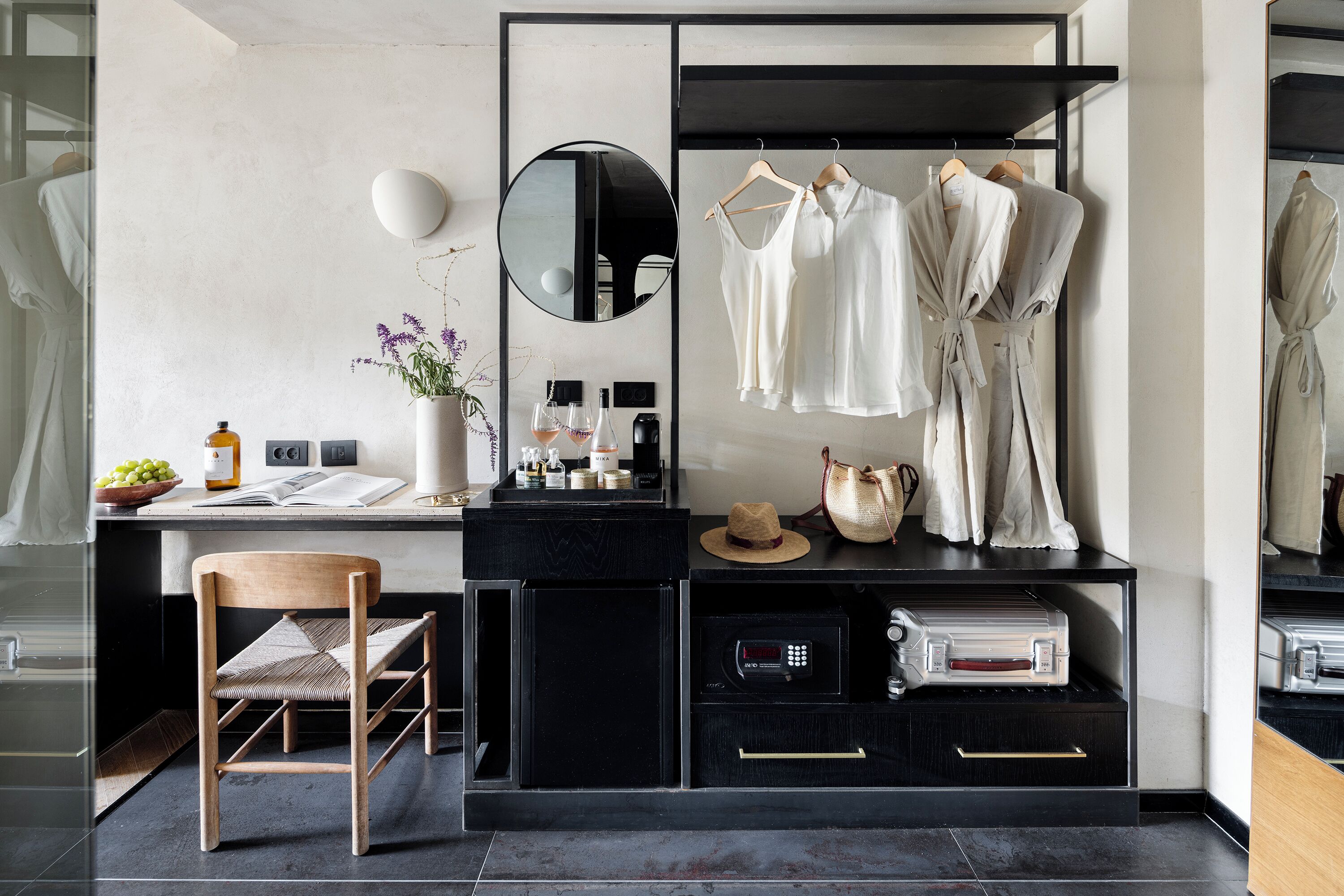 A modern bathroom with a mirror, towel rack, and a sink.