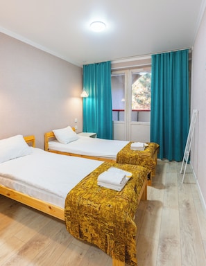 A room with two beds, a window with curtains, a radiator, and a wooden floor. - ololoAkJol (Kosh-Kel)
