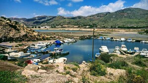 A marina with boats docked, surrounded by hills and a clear sky. - Cosy, luxury 2-bed golf villa (La Manga Club) (Cartagena)