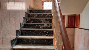 A staircase with marble steps and a wooden handrail. - Vacation house, sleeps 6, in Noto 500 mt from the center. (Noto)
