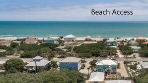 An aerial view of a coastal residential area with beach access indicated by a red line. - Welcome to Boomerang! (St. George Island)