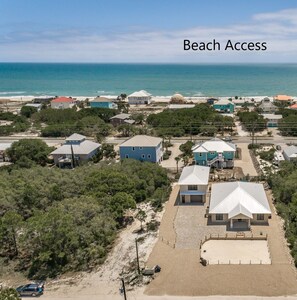 An aerial view of a coastal residential area with beach access indicated by a red line. - Welcome to Boomerang! (St. George Island)