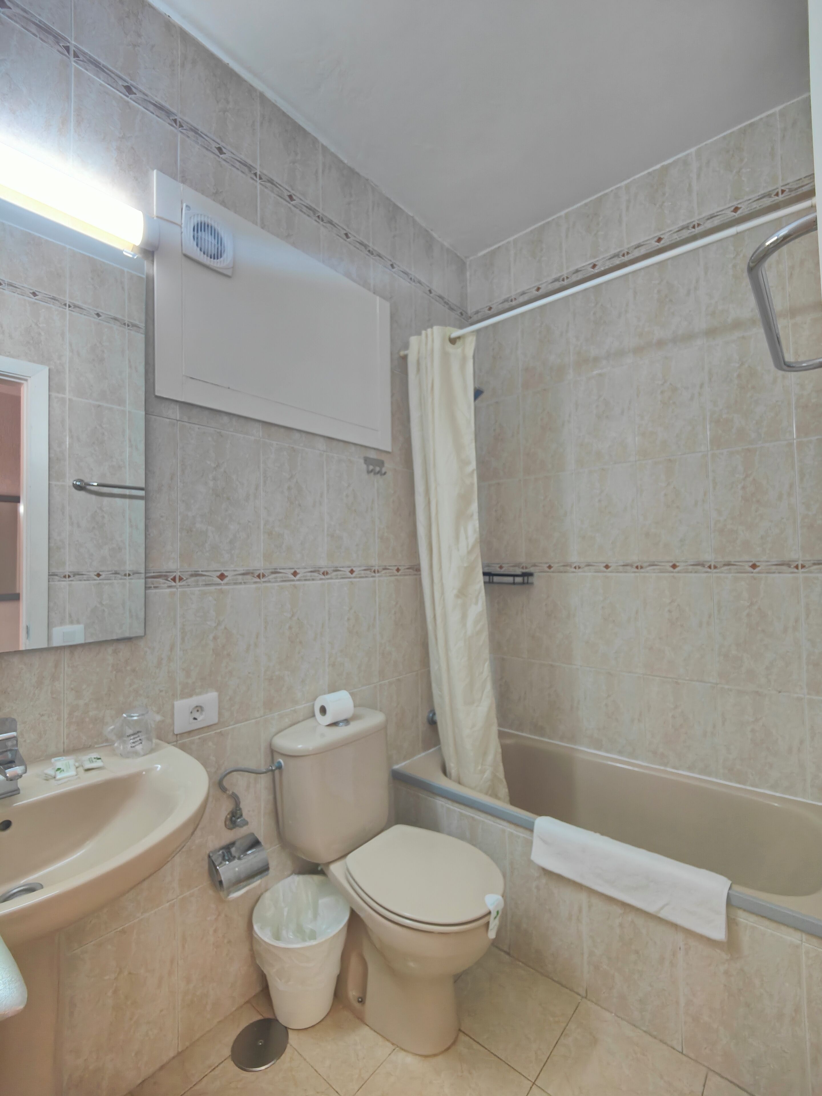 A bathroom with a sink, toilet, and bathtub.