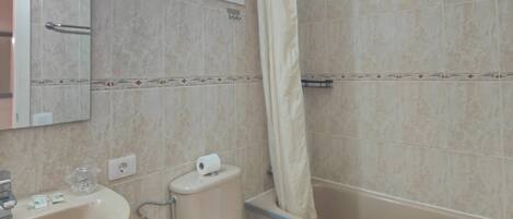 A bathroom with a sink, toilet, and bathtub.