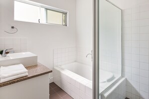Bathtub, towels, toilet paper