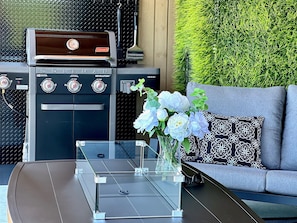 Enjoy al fresco dining with a gas grill and outdoor seating area.