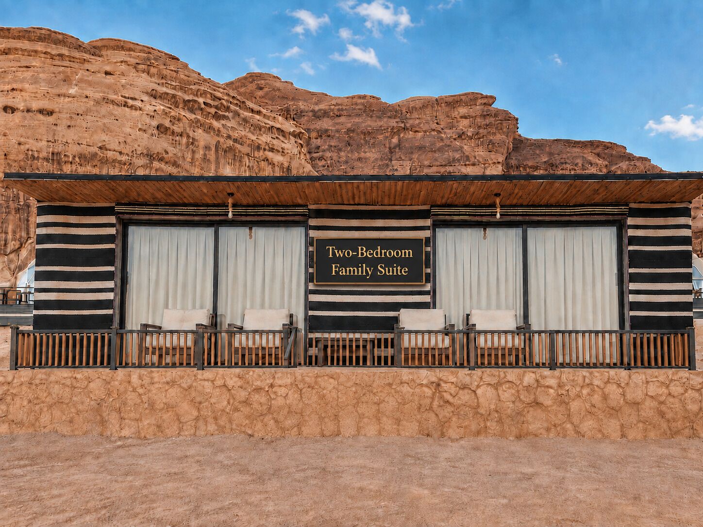 A two-bedroom family suite with a view of a desert landscape.