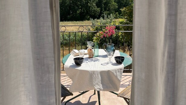A table set outdoors with a view of green hills in the background. -  Bastide 1830, Domaine de la Bastidonne 4* Superb view of le Luberon Heated Pool (Céreste)