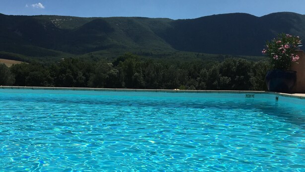 A poolside view with a striped towel, sunglasses, and a book. - Lavender, Luberon view, pool, air-conditioning : Villa Mas des Lavandes 2 BR. 4* (Céreste)