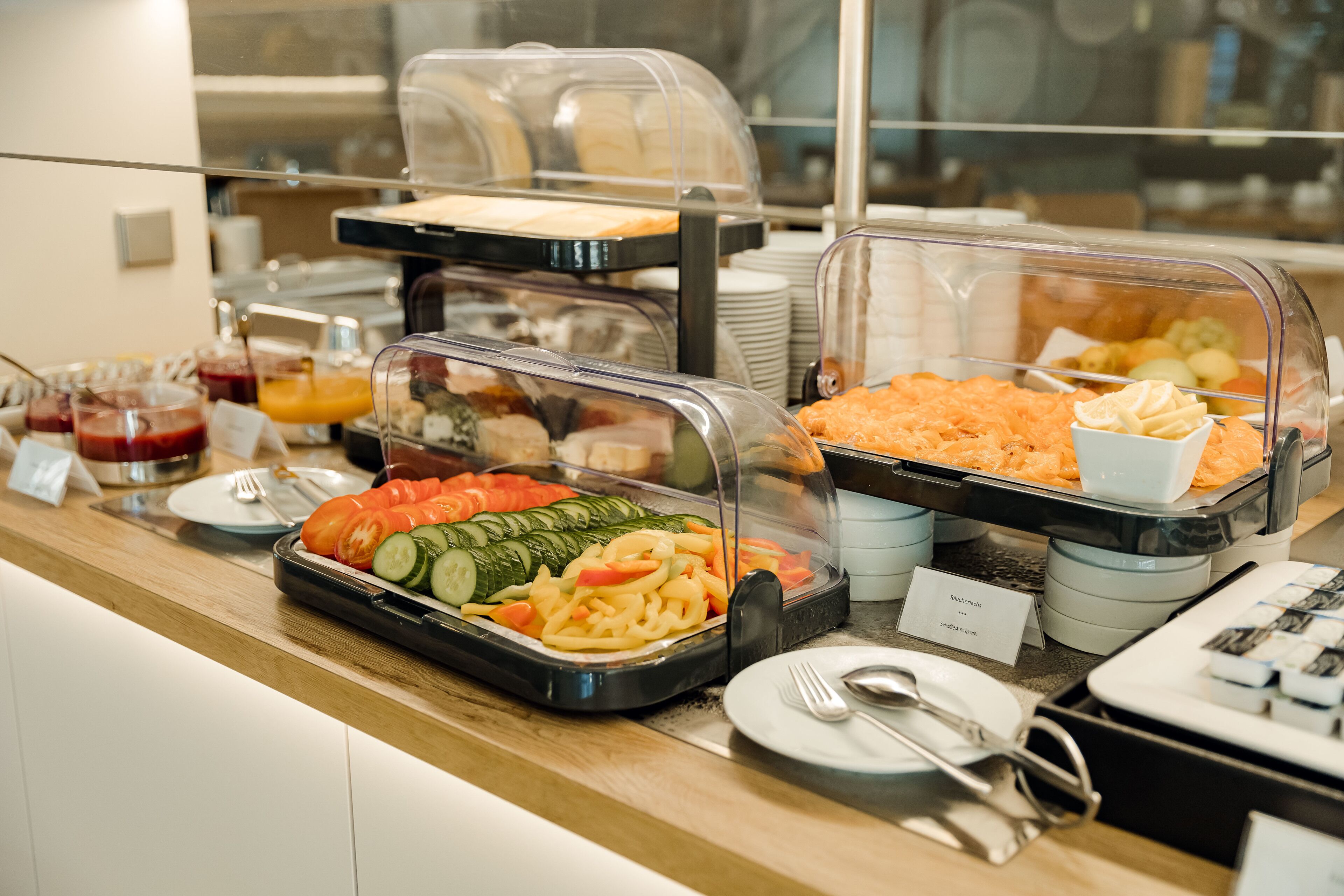 A buffet with various food items including fruits, vegetables, and prepared dishes.