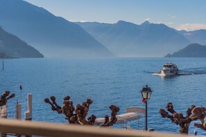A boat on a calm lake with mountains in the background.