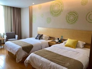 A hotel room with two beds, a chair, a nightstand, and a wall with circular patterns. - Greentree Inn Nantong Qidong Binhai Industrial Park Zone Nanhai Road Express Hotel (Nantong)