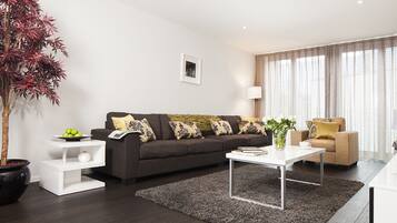 Signature Apartment, 2 Bedrooms, Non Smoking, City View | Living room | 50-inch flat-screen TV with cable channels, TV