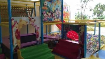A children's play area with a soft play zone, a ball pit, and a climbing structure.