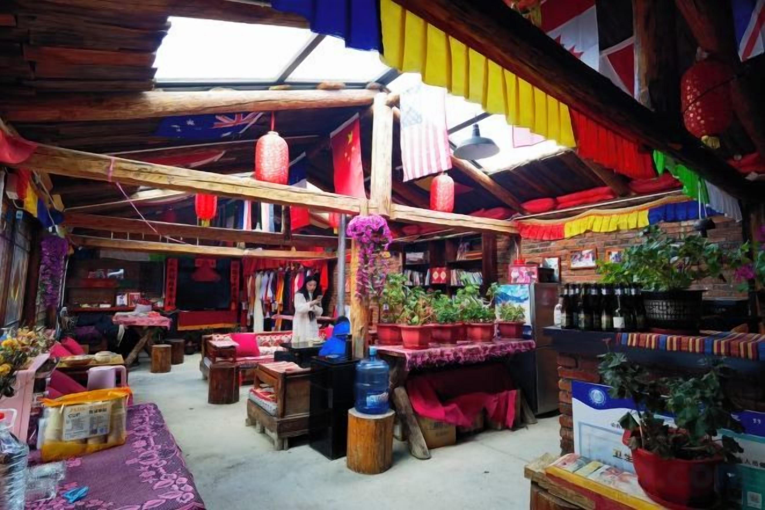 A traditional market with wooden stalls and hanging lanterns.