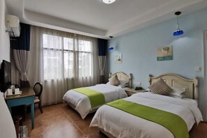 A hotel room with two beds, a desk, a chair, and a television. - No. 1 Inn @ the Corner (Zhangjiajie)