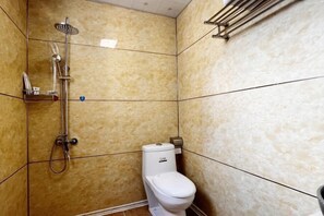 A bathroom with a shower, toilet, and a towel rack. - No. 1 Inn @ the Corner (Zhangjiajie)