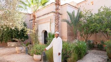 Stroll through a tranquil courtyard surrounded by lush greenery and traditional architecture.