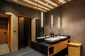 A modern bathroom with two sinks, a large mirror, and a wooden vanity. -  Sleepover Terminal 3, Concourse B – formerly sleep ‘n fly (Dubai)